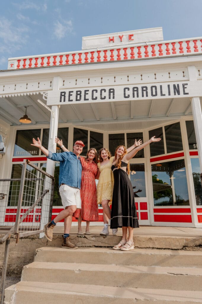 The Rebecca Caroline family on the steps of the historic Hye Post Office in Hye, Texas
