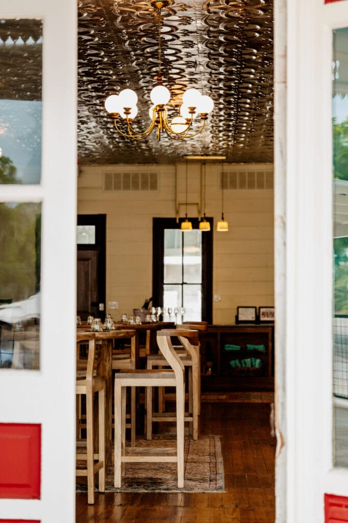 A corner of the tasting room with bar stools beneath the pressed-tin ceiling